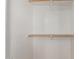 This bright walk-in closet provides ample storage space with wooden rods and shelving at 2000 N 36Th St # 41, Phoenix, AZ 85008