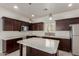 Modern kitchen featuring dark cabinets, stainless steel appliances, a mosaic backsplash, and an island at 2000 N 36Th St # 41, Phoenix, AZ 85008