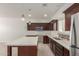 Bright and spacious kitchen with stainless steel appliances, dark wood cabinets and quartz countertops at 2000 N 36Th St # 41, Phoenix, AZ 85008