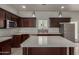 Modern kitchen featuring dark wood cabinets, stainless steel appliances, quartz countertops, and pendant lighting at 2000 N 36Th St # 41, Phoenix, AZ 85008