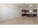 Spacious kitchen with dark wood cabinets, stainless steel appliances, and an island with a quartz countertop at 2000 N 36Th St # 41, Phoenix, AZ 85008