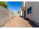 View of backyard, with stucco wall, stone groundcover and door at 2000 N 36Th St # 8, Phoenix, AZ 85008