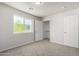 Bright bedroom with large window and neutral colored carpet at 2000 N 36Th St # 8, Phoenix, AZ 85008