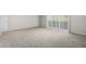 Bright bedroom featuring neutral carpet, light walls, and sliding glass door access to the outdoors at 2000 N 36Th St # 8, Phoenix, AZ 85008