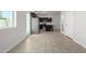 Open kitchen and living room with stainless steel appliances, tile floors, and white walls at 2000 N 36Th St # 8, Phoenix, AZ 85008