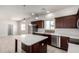 Stylish kitchen island with stainless steel appliances and pendant lighting at 2000 N 36Th St # 8, Phoenix, AZ 85008