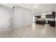 Open-concept living area showcasing tile flooring, staircase, and kitchen with island at 2000 N 36Th St # 8, Phoenix, AZ 85008