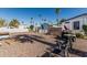 Backyard with gravel landscaping, chairs, and storage sheds, partially shaded at 2060 N Center St # 133, Mesa, AZ 85201