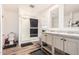 Bright bathroom features dual sinks, a walk-in shower, and wood-look floors at 2060 N Center St # 133, Mesa, AZ 85201
