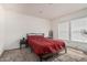 Bedroom with neutral walls, carpeted floors, and a large bed with a red comforter at 2060 N Center St # 133, Mesa, AZ 85201