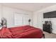 Bedroom featuring carpeted floors and a TV with a black dresser at 2060 N Center St # 133, Mesa, AZ 85201