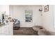Bright bonus room with laminate flooring featuring a dog crate and comfortable dog bed at 2060 N Center St # 133, Mesa, AZ 85201