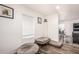 Well-lit bonus room with laminate flooring and dog beds by bright windows at 2060 N Center St # 133, Mesa, AZ 85201