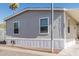 Charming single-story home with gray siding and carport in a sunny community at 2060 N Center St # 133, Mesa, AZ 85201