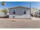 Charming single-story home with gray siding and carport on a sunny day at 2060 N Center St # 133, Mesa, AZ 85201