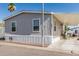 Charming single-story home with gray siding and carport in a sunny community at 2060 N Center St # 133, Mesa, AZ 85201
