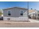 Charming single-story home with gray siding and carport in a sunny community at 2060 N Center St # 133, Mesa, AZ 85201