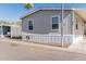 Charming single-story home with gray siding and carport in a sunny community at 2060 N Center St # 133, Mesa, AZ 85201