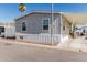 Charming single-story home with gray siding and carport in a sunny community at 2060 N Center St # 133, Mesa, AZ 85201