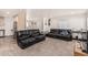 Bright living room featuring plush black couches and an open floor plan at 2060 N Center St # 133, Mesa, AZ 85201