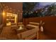 Charming back patio with cozy seating, pavers, ambient lighting, and tranquil fire pit at 2062 W Roy Rogers Rd, Phoenix, AZ 85085