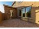 Private paver patio with access to the home, windows, and views of desert landscaping at 2062 W Roy Rogers Rd, Phoenix, AZ 85085
