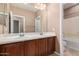 Bathroom featuring dual sinks with vanity and granite countertop, walk-in shower, and tile floors at 2062 W Roy Rogers Rd, Phoenix, AZ 85085