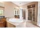 Bathroom featuring a walk-in shower, vanity with granite countertop, and a deck-mounted bathtub at 2062 W Roy Rogers Rd, Phoenix, AZ 85085