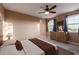 A staged bedroom features carpet, a ceiling fan, and a large window with views at 2062 W Roy Rogers Rd, Phoenix, AZ 85085