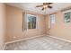 Bedroom featuring carpet floors, ceiling fan, and large windows with curtains letting in natural sunlight at 2062 W Roy Rogers Rd, Phoenix, AZ 85085