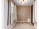 Bright entryway with tile flooring, coat hooks, and natural light at 2062 W Roy Rogers Rd, Phoenix, AZ 85085