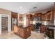 This kitchen features granite counters, stainless appliances, tile flooring, and a large island with seating at 2062 W Roy Rogers Rd, Phoenix, AZ 85085
