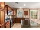 Kitchen featuring granite countertops, tile backsplash, stainless appliances, and a view out of the window at 2062 W Roy Rogers Rd, Phoenix, AZ 85085