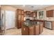 A beautiful kitchen featuring granite countertops, stainless appliances, an island, and a tiled floor at 2062 W Roy Rogers Rd, Phoenix, AZ 85085