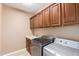 Laundry Room featuring washer and dryer, tile floors, and custom storage cabinets above sink and counter at 2062 W Roy Rogers Rd, Phoenix, AZ 85085