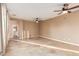 Large living space with tile floors, ceiling fans, and view into an attached bathroom at 2062 W Roy Rogers Rd, Phoenix, AZ 85085