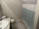 Bright bathroom featuring granite counters, tile floors, and an updated shower curtain at 22325 N 185Th Ave, Surprise, AZ 85387