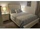 Cozy bedroom with a queen bed, soft lighting, and a decorative headboard at 22325 N 185Th Ave, Surprise, AZ 85387