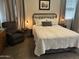 Comfortable bedroom featuring a queen bed, reading nook, and ambient lighting at 22325 N 185Th Ave, Surprise, AZ 85387