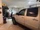 Clean garage showcasing epoxied floors, overhead storage and a silver pickup truck at 22325 N 185Th Ave, Surprise, AZ 85387