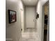 Hallway with tile floors that leads to the bedrooms, providing ample space for traffic at 22325 N 185Th Ave, Surprise, AZ 85387