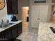 Modern kitchen with dark cabinets, granite countertops, stainless steel sink, and appliances at 22325 N 185Th Ave, Surprise, AZ 85387