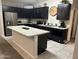Stylish kitchen featuring modern appliances, dark cabinets, and a granite island at 22325 N 185Th Ave, Surprise, AZ 85387