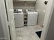 Laundry room with large capacity appliances and tile flooring for convenience at 22325 N 185Th Ave, Surprise, AZ 85387
