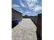 Paver-lined side yard leading to backyard with secure privacy gate at 22325 N 185Th Ave, Surprise, AZ 85387