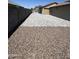 Spacious side yard features decorative rocks for low maintenance and leads to the backyard at 22325 N 185Th Ave, Surprise, AZ 85387