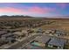 Sunset aerial view of desert homes displaying the picturesque neighborhood against a colorful sky at 22657 N 184Th Ln, Surprise, AZ 85387