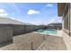 Scenic backyard featuring a sparkling pool, spa, and low-maintenance desert landscaping at 22657 N 184Th Ln, Surprise, AZ 85387