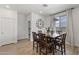 Cozy dining area with wood table and chairs, modern light fixture, and open layout with access to other living spaces at 22657 N 184Th Ln, Surprise, AZ 85387