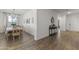 Bright dining area with seating for six, wood floors, neutral walls, and stylish decor elements at 22657 N 184Th Ln, Surprise, AZ 85387